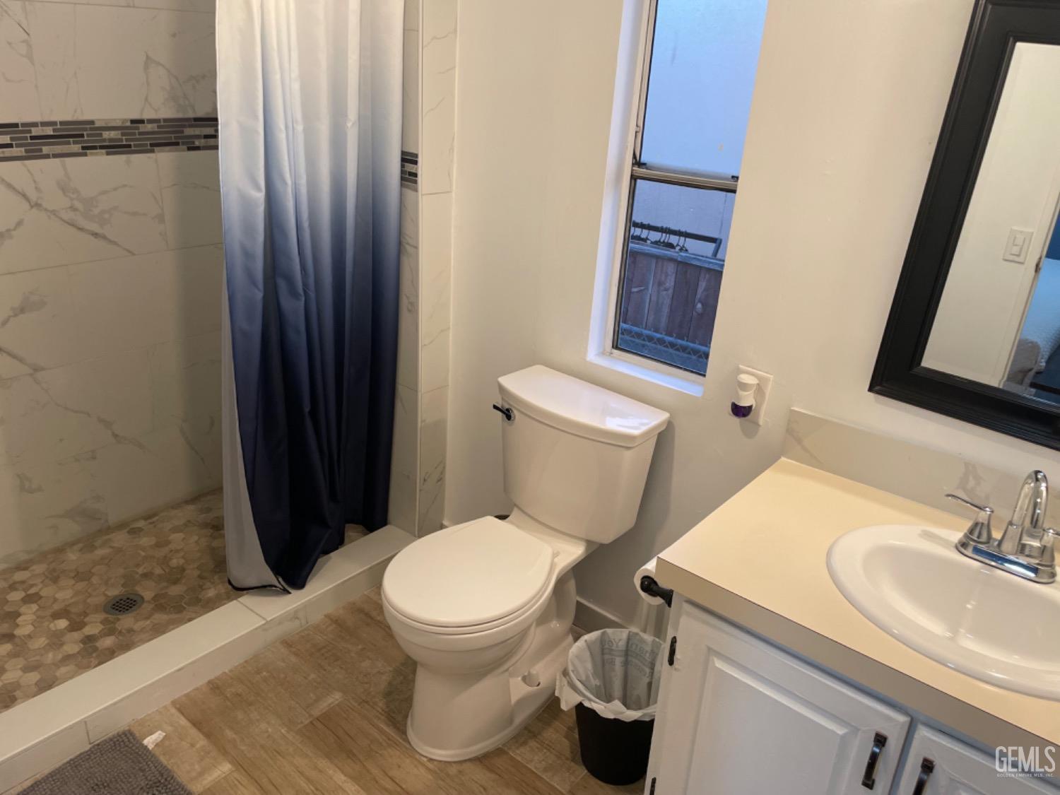 Undisclosed Address Bakersfield, CA 93304 - Photo 13 of 24 a white toilet sitting next to a bathroom sink