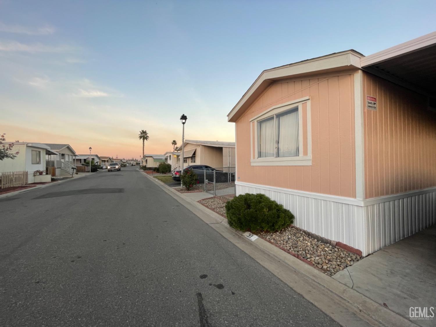 Undisclosed Address Bakersfield, CA 93304 - Photo 20 of 24 a view of a street with cars parked in front of it