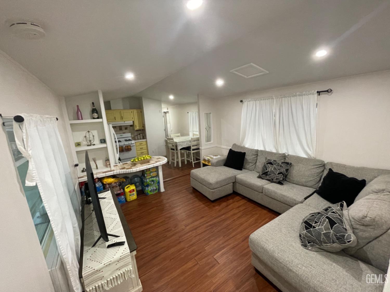 Undisclosed Address Bakersfield, CA 93304 - Photo 6 of 24 a living room with furniture and wooden floor