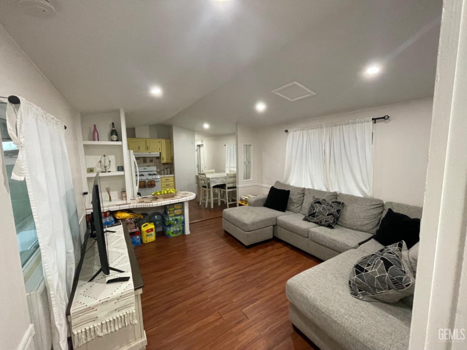 Undisclosed Address Bakersfield, CA 93304 - Photo 7 of 24 a living room with furniture wooden floor and kitchen view