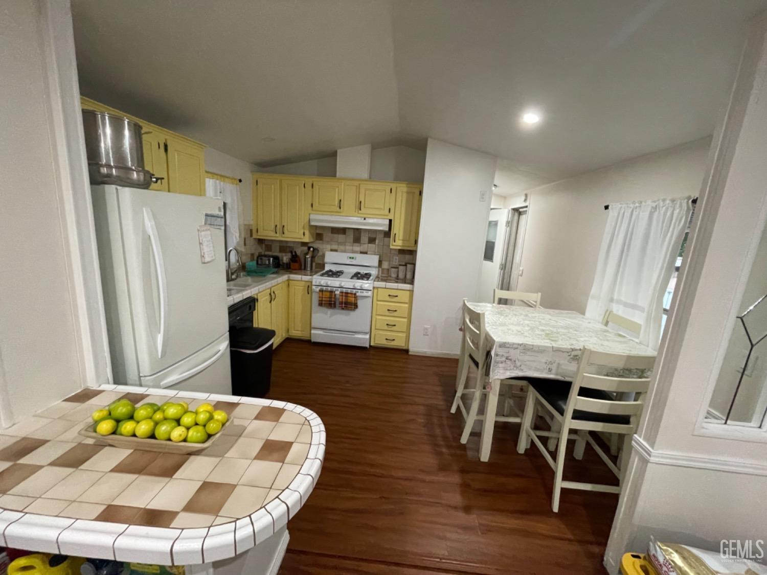 Undisclosed Address Bakersfield, CA 93304 - Photo 9 of 24 a kitchen with stainless steel appliances granite countertop a refrigerator and a stove top oven