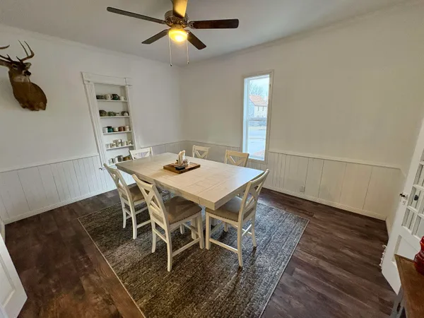 a view of a dining room with furniture and wooden floor