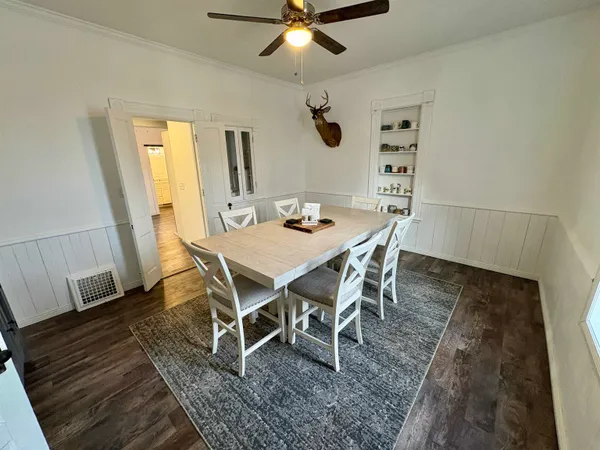 a view of a dining room with furniture and wooden floor