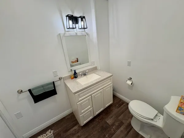 a white toilet sitting next to a bathroom sink