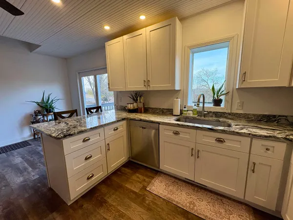 a kitchen with sink cabinets and window