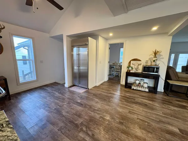 a view of a livingroom with furniture and a flat screen tv