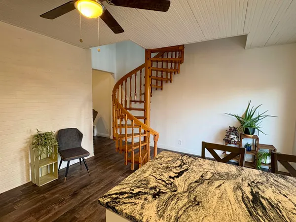 a view of a livingroom with furniture and wooden floor
