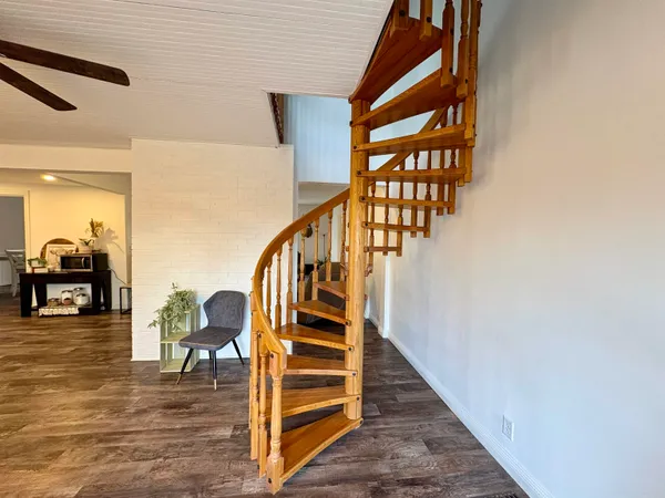 a view of entryway and hall with wooden floor