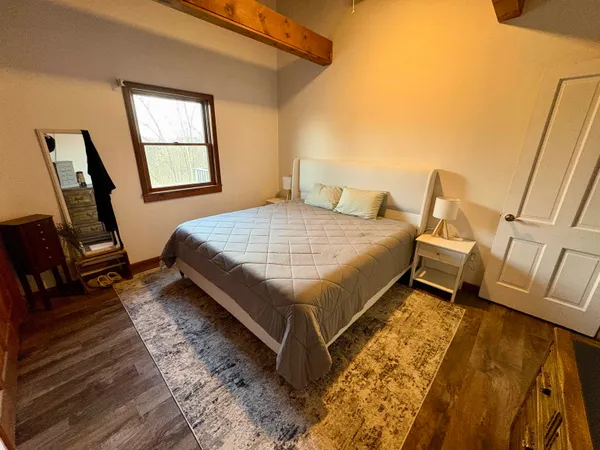 a bed sitting in a bedroom next to a window