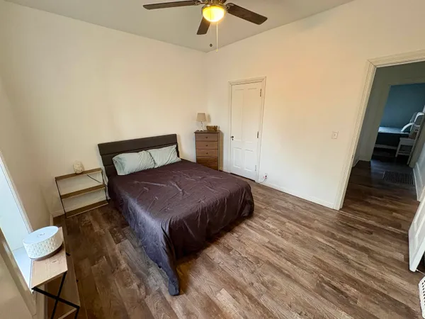 a bedroom with a bed and a chandelier