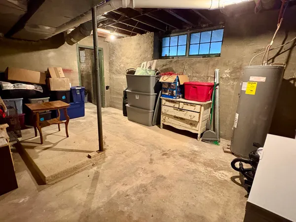 a garage with a couch and a stove next to a blue umbrella