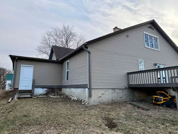 a view of a house with a patio and a yard