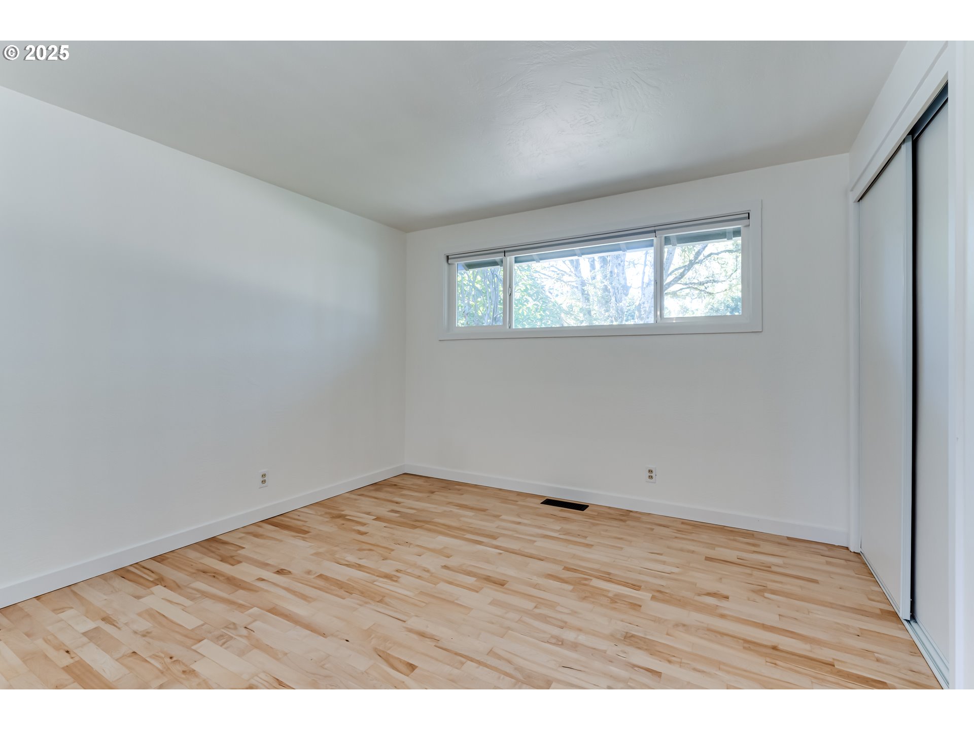395 Fairway Loop Eugene, OR 97401 - Photo 17 of 37 an empty room with wooden floor and windows