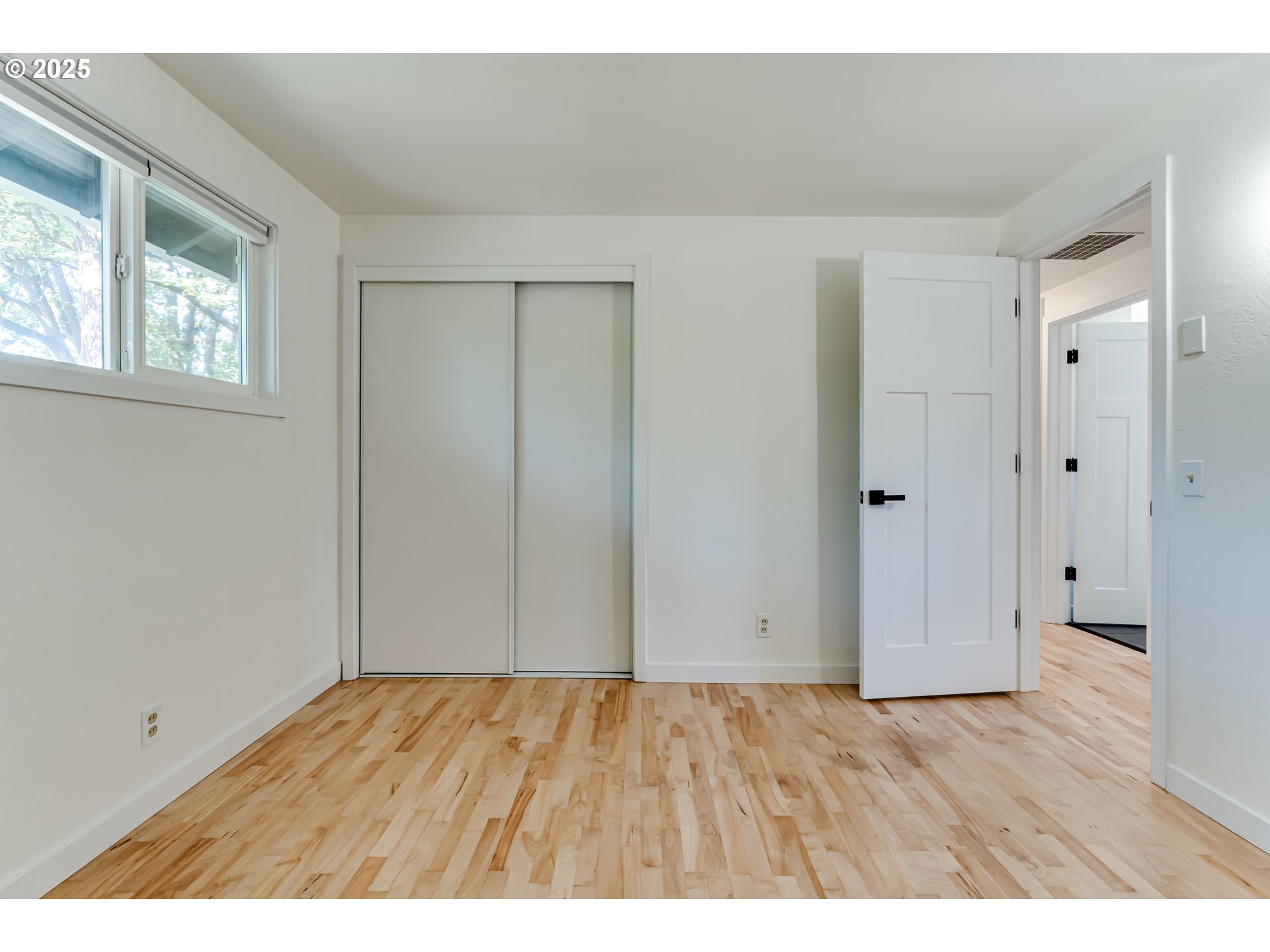 395 Fairway Loop Eugene, OR 97401 - Photo 18 of 37 a view of an empty room with wooden floor and a window