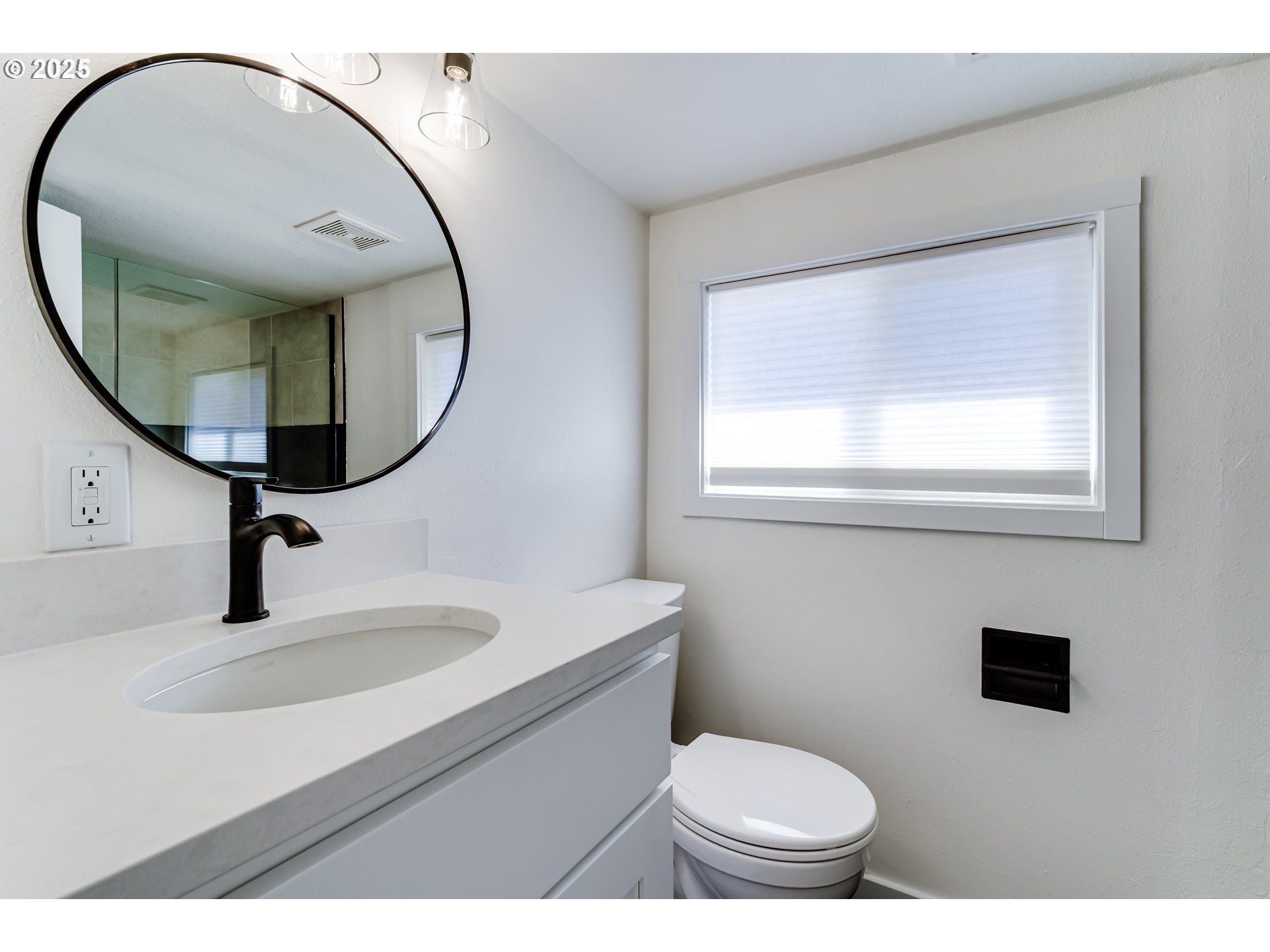 395 Fairway Loop Eugene, OR 97401 - Photo 27 of 37 a bathroom with a toilet a sink and a mirror
