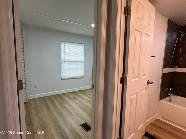 a view of an empty room and a window