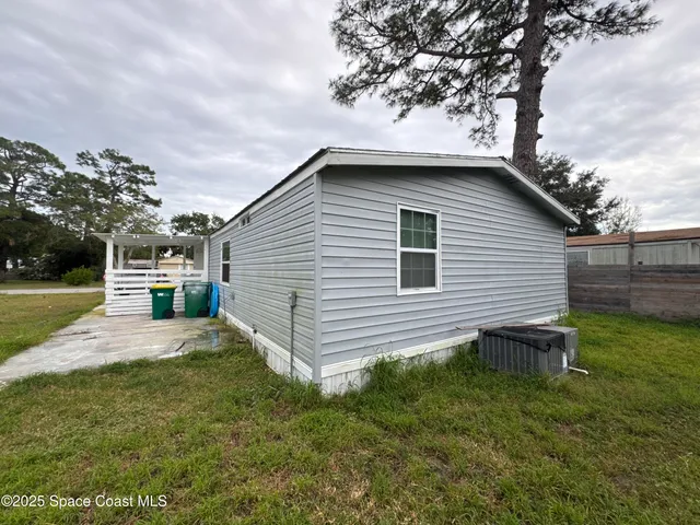 a view of a backyard with wooden fence