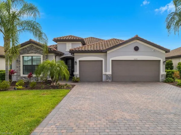 a front view of a house with a yard and garage