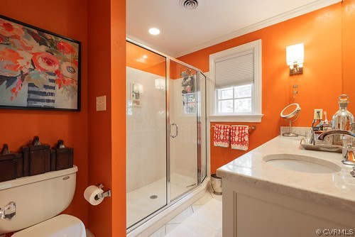 7720 Kenmore Circle Richmond, VA 23225 - Photo 24 of 48 a bathroom with a sink a toilet a mirror and shower