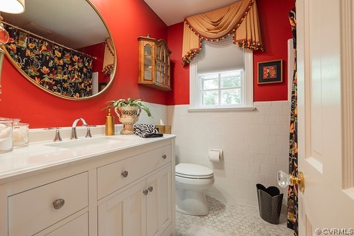 7720 Kenmore Circle Richmond, VA 23225 - Photo 31 of 48 a bathroom with a toilet sink and mirror