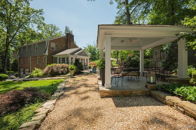 7720 Kenmore Circle Richmond, VA 23225 - Photo 4 of 48 a view of a patio with table and chairs potted plants and large tree