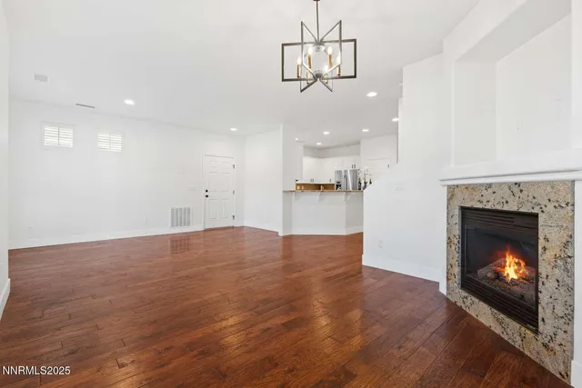 a view of a kitchen a kitchen a fireplace a sink and a chandelier