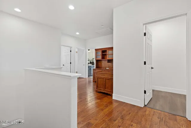 a view of a kitchen with a refrigerator and a stove top oven