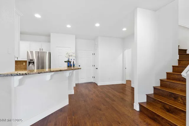 a view of entryway and hall with wooden floor