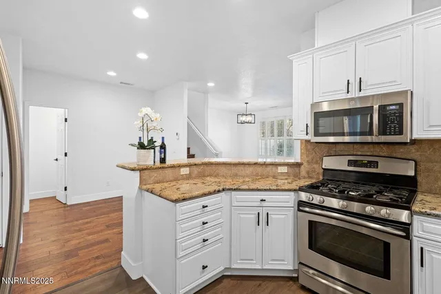a kitchen with granite countertop a stove and a sink