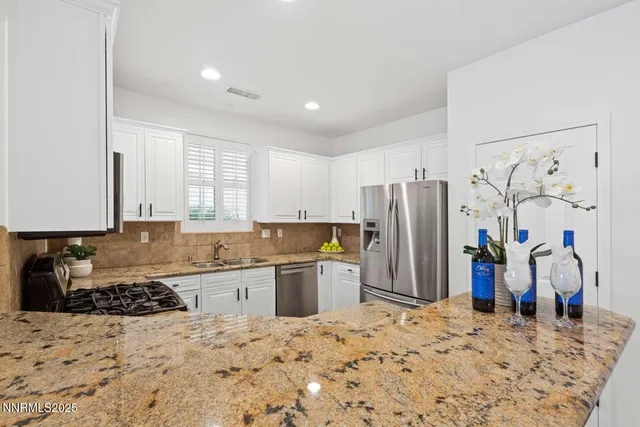 a kitchen with a refrigerator and a sink