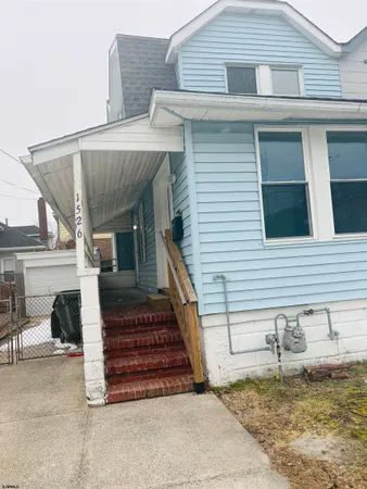a front view of a house with stairs