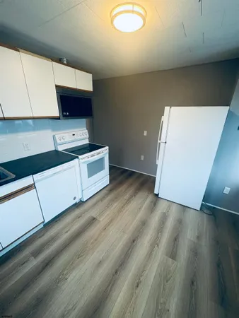 a kitchen with a wooden floor and a stove