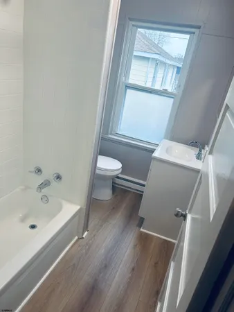 a bathroom with a bathtub sink and toilet