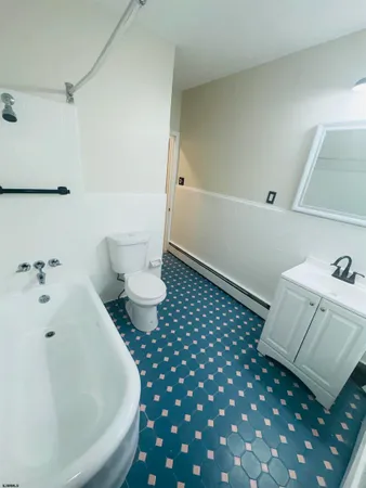 a bathroom with a bathtub and toilet