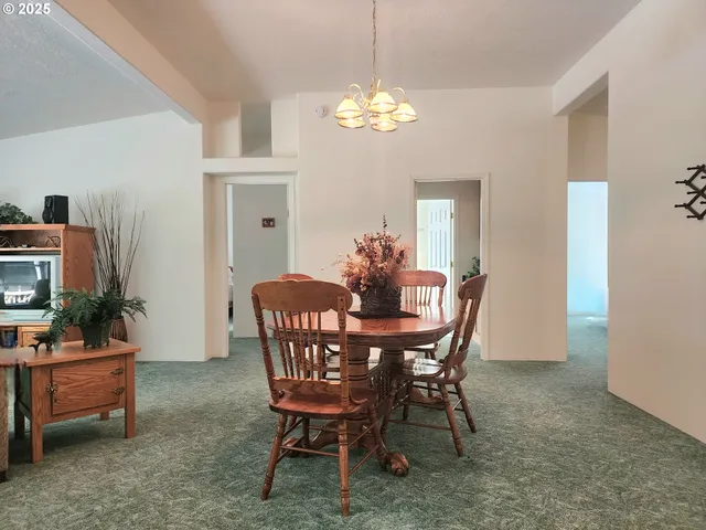 a dining room with furniture and chandelier