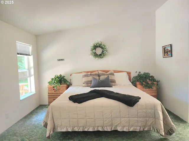 a bedroom with a bed and window