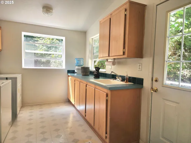 a kitchen with stainless steel appliances granite countertop a sink a stove and a refrigerator