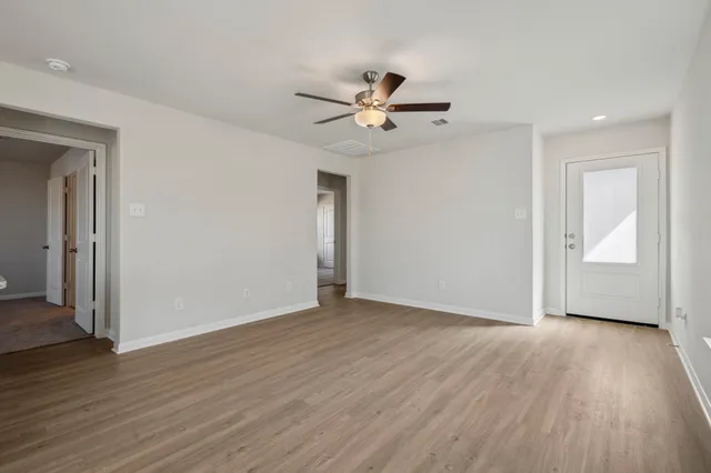 wooden floor in an empty room with a window