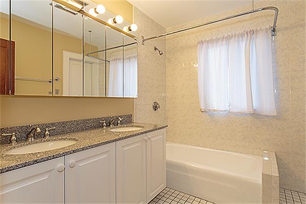 59 Coolidge Road Arlington, MA 02476 - Photo 15 of 22 a bathroom with a granite countertop sink and a bathtub