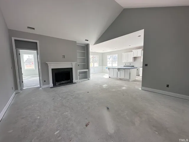 a view of empty room with a fireplace