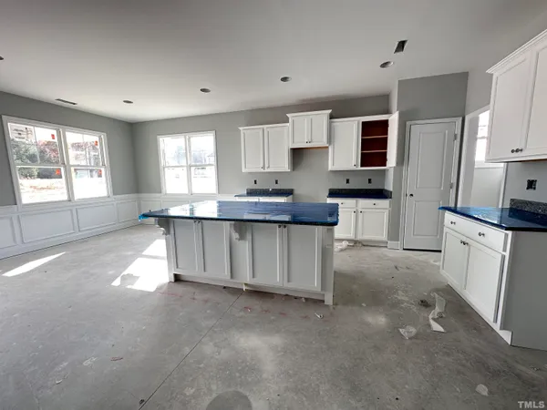 a kitchen with stainless steel appliances kitchen island granite countertop a sink and cabinets