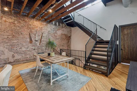 a view of a dining room with furniture wooden floor and stairs