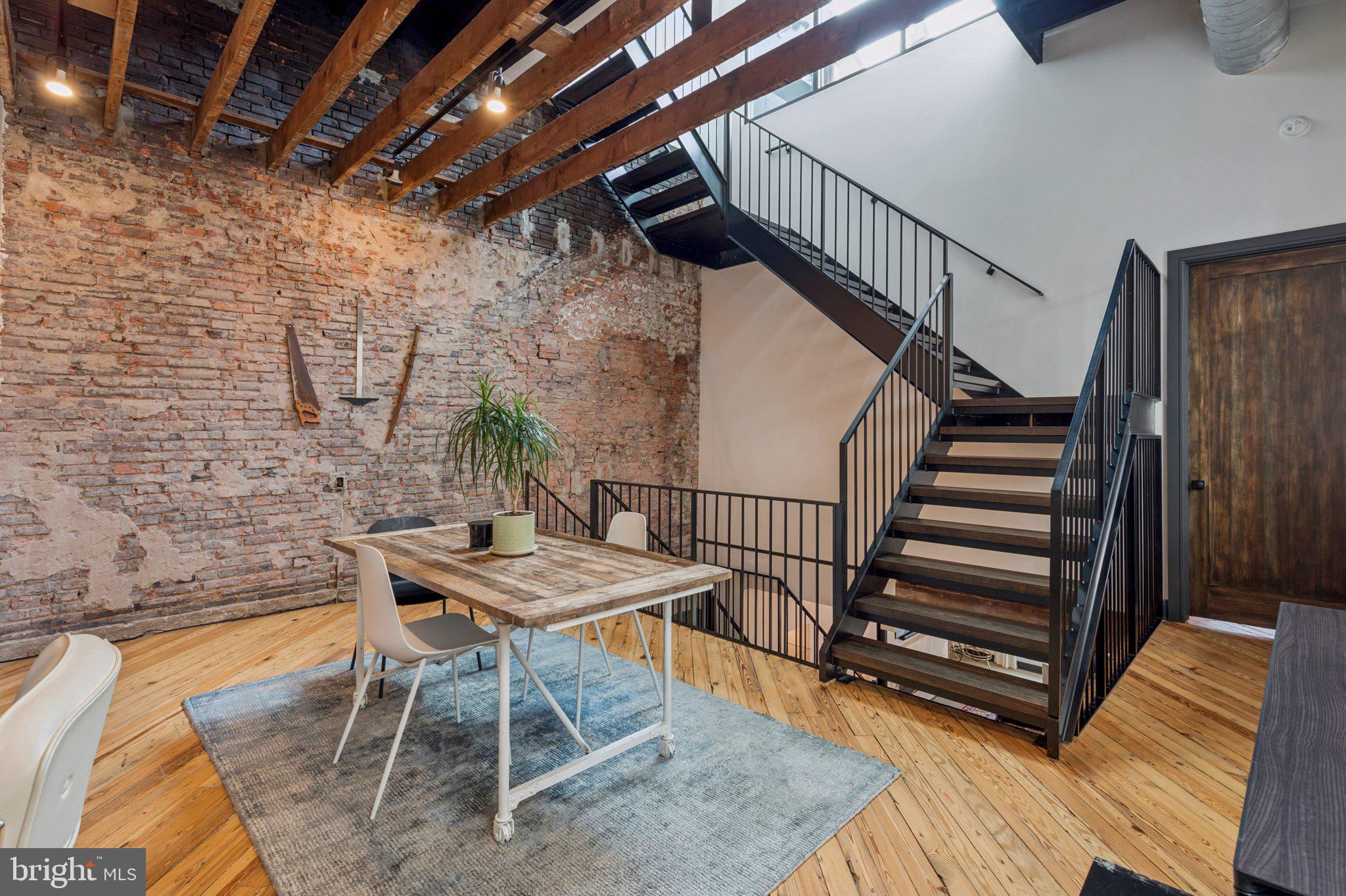 207 South 24th Street Philadelphia, PA 19103 - Photo 19 of 47 a view of a dining room with furniture wooden floor and stairs