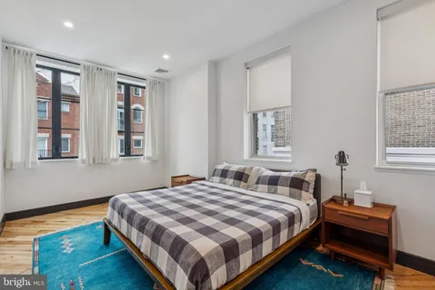 a bedroom with bed and a window