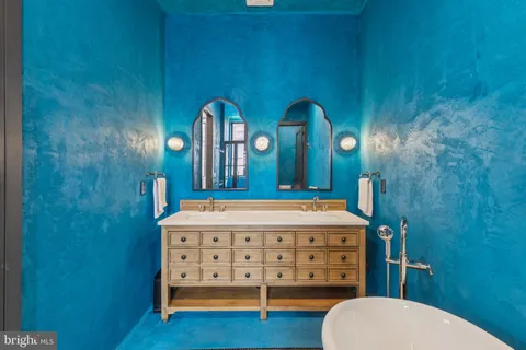a bathroom with a sink a mirror a toilet and a bathtub