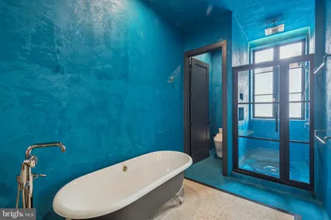 a bathroom with a toilet and a shower