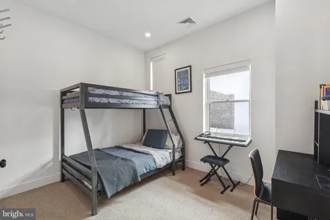 a bedroom with a bed and a desk