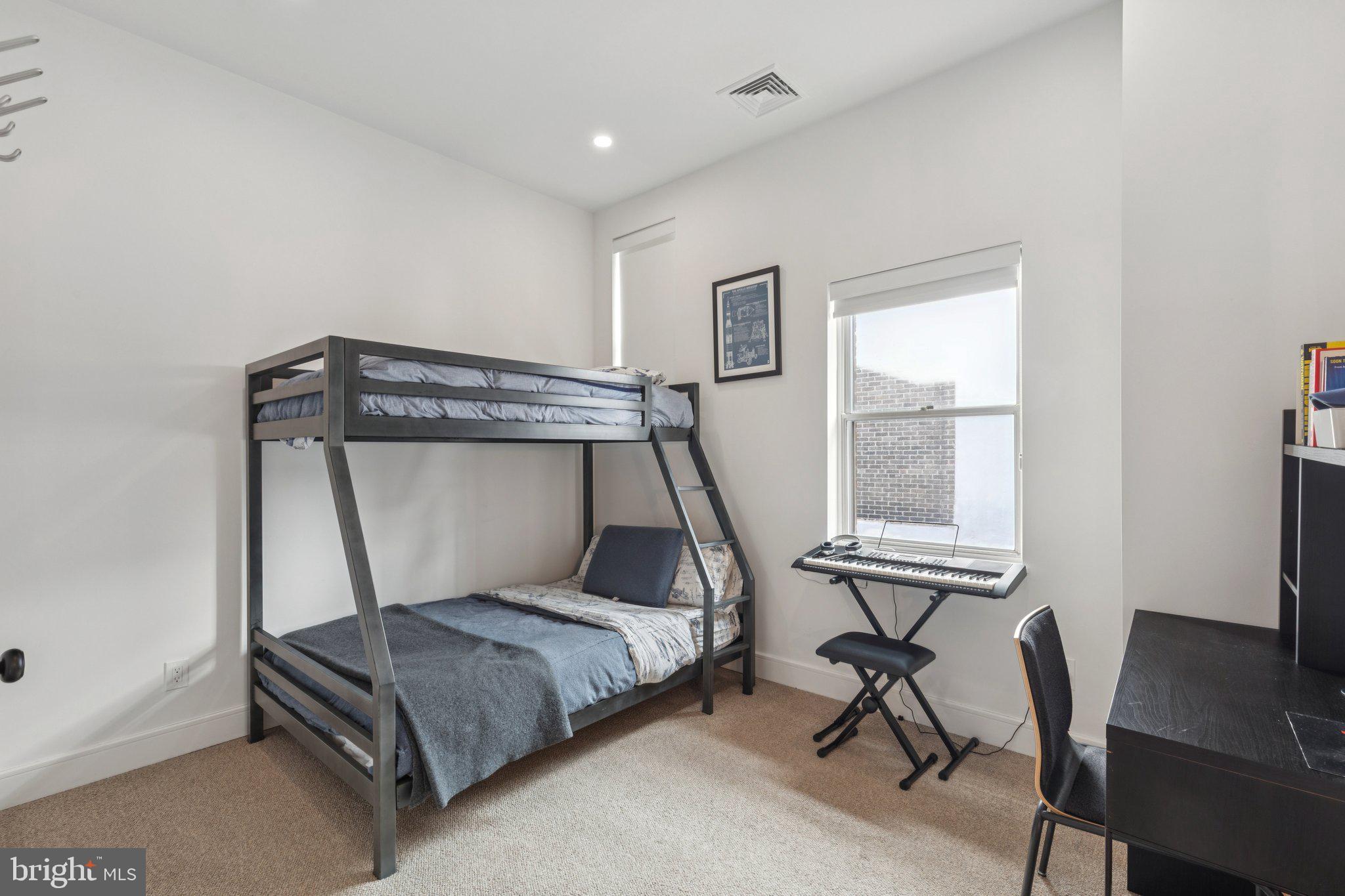 207 South 24th Street Philadelphia, PA 19103 - Photo 25 of 47 a bedroom with a bed and a desk