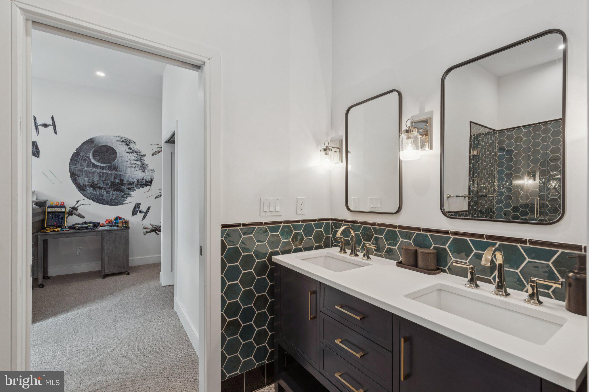 207 South 24th Street Philadelphia, PA 19103 - Photo 27 of 47 a en suite bathroom with a double vanity sink and a mirror