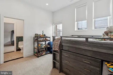 a view of a room that has a dresser and a window